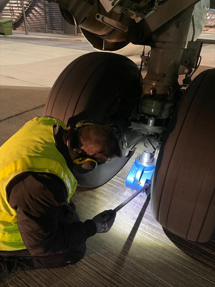 Tangye Hydralite jack being positioned to raise the wheel axle.