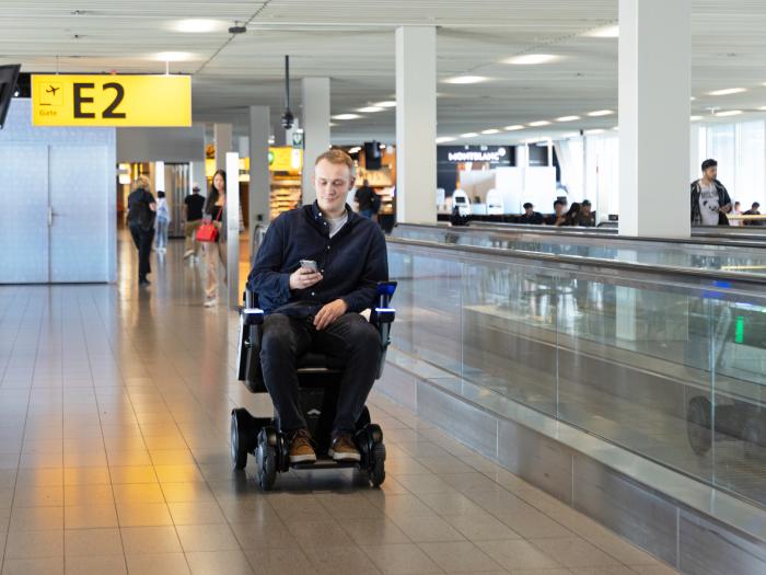 The wheelchair has a rack for hand luggage