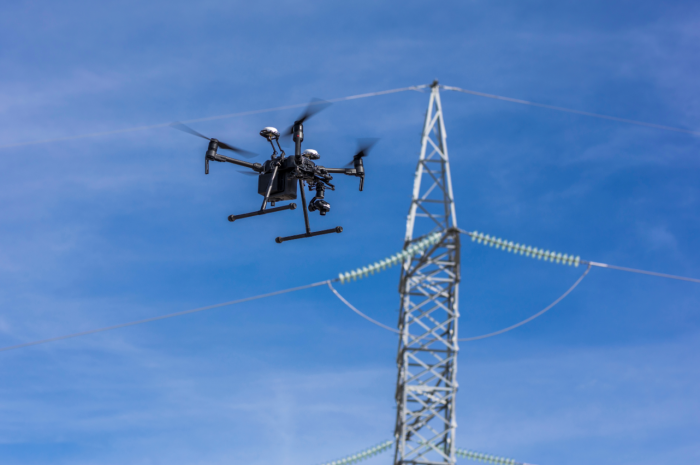 A drone inspecting a power line